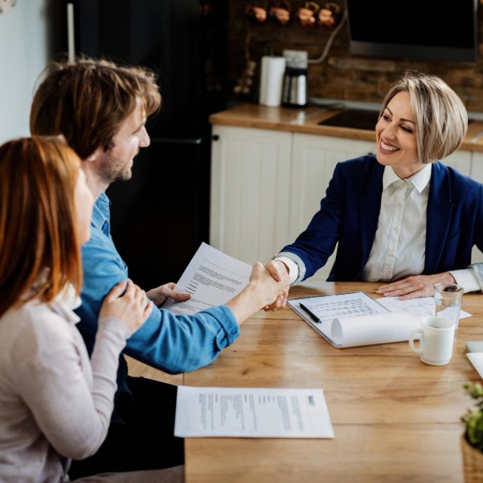 happy-insurance-agent-shaking-hands-with-young-couple-after-successful-meeting happy-insurance-agent-shaking-hands-with-young-couple-after-successful-meeting