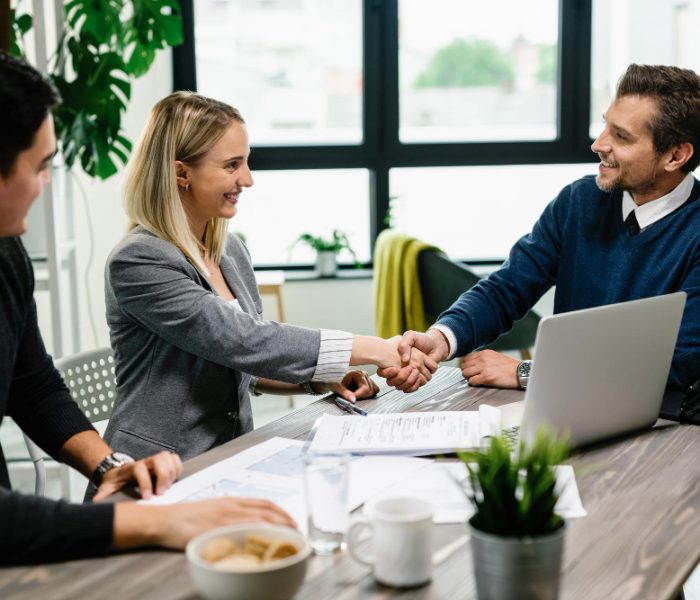 young-happy-couple-meeting-with-financial-advisor-office-woman-is-handshaking-with-agent